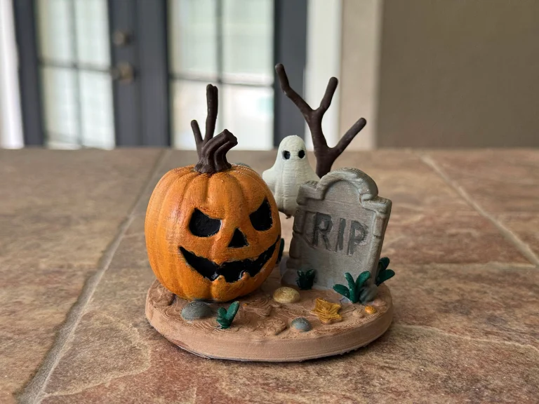 Painted pumpkin scene with a little ghost and a tombstone