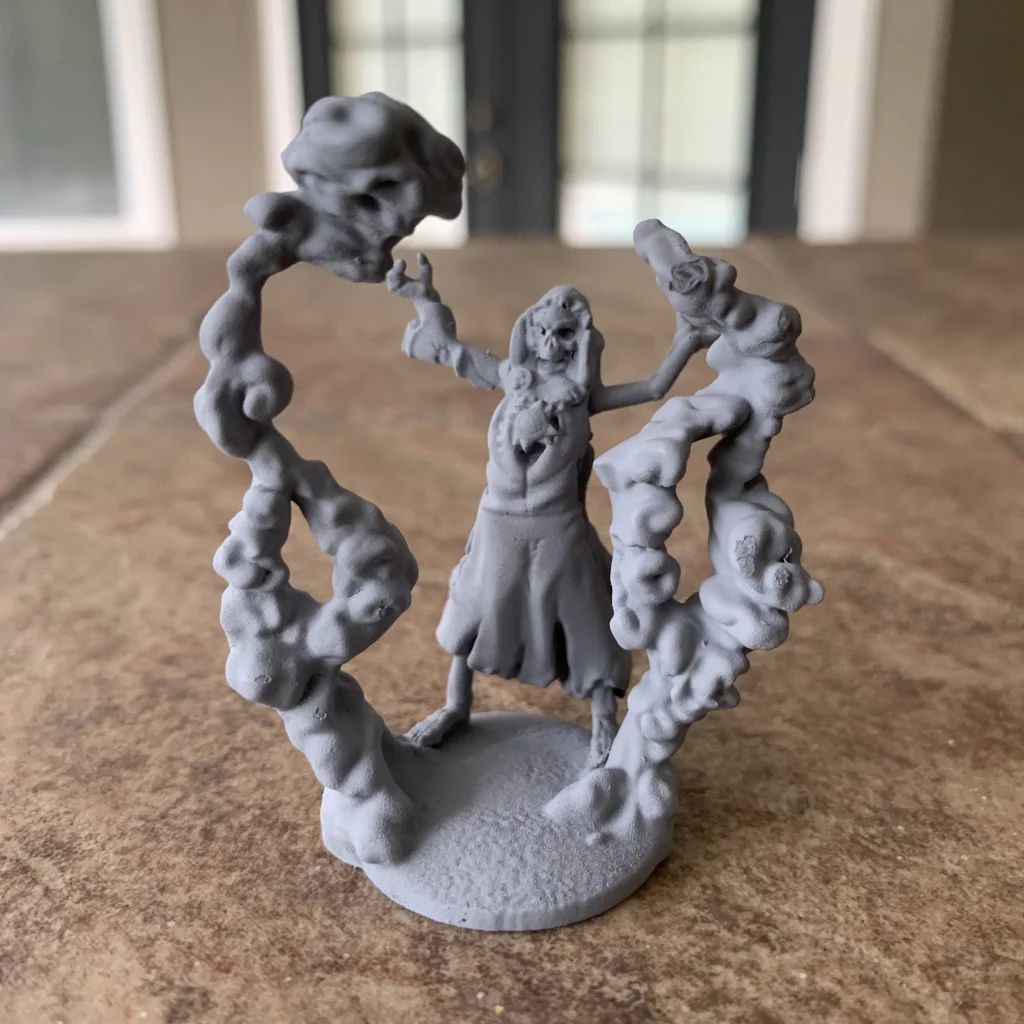 Skeleton necromancer miniature with swirling dark energy and skulls rising from its base