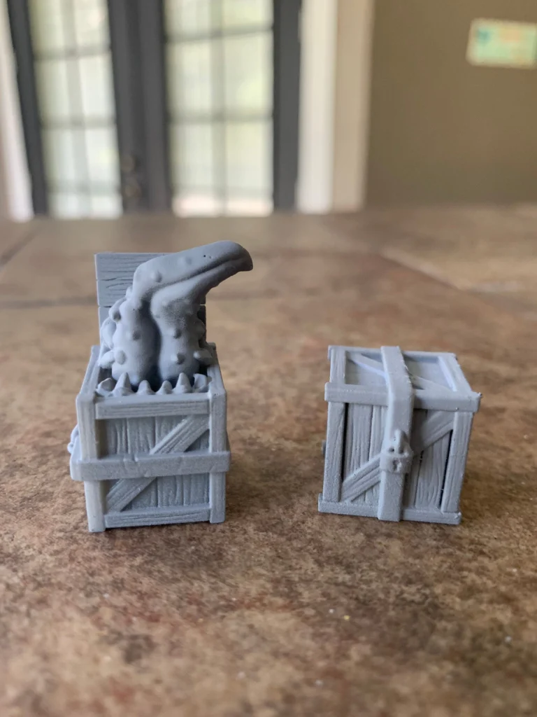 Crate mimic miniature set: a crate with a tentacled monster bursting out, beside a closed crate