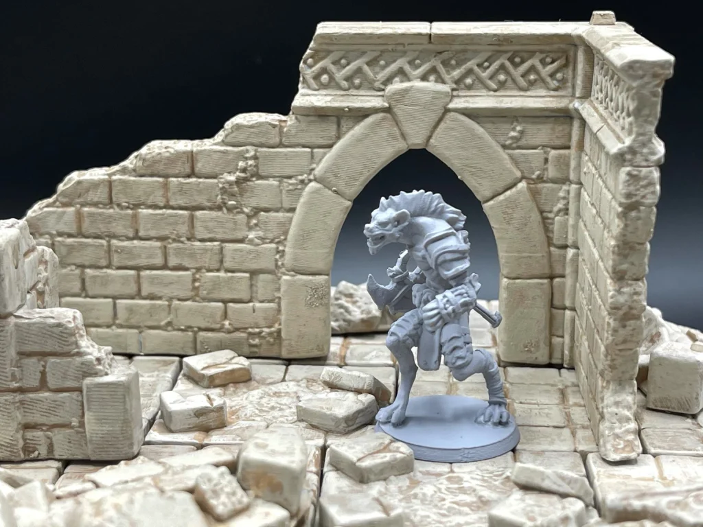 Gnoll miniature in front of a ruined stone archway