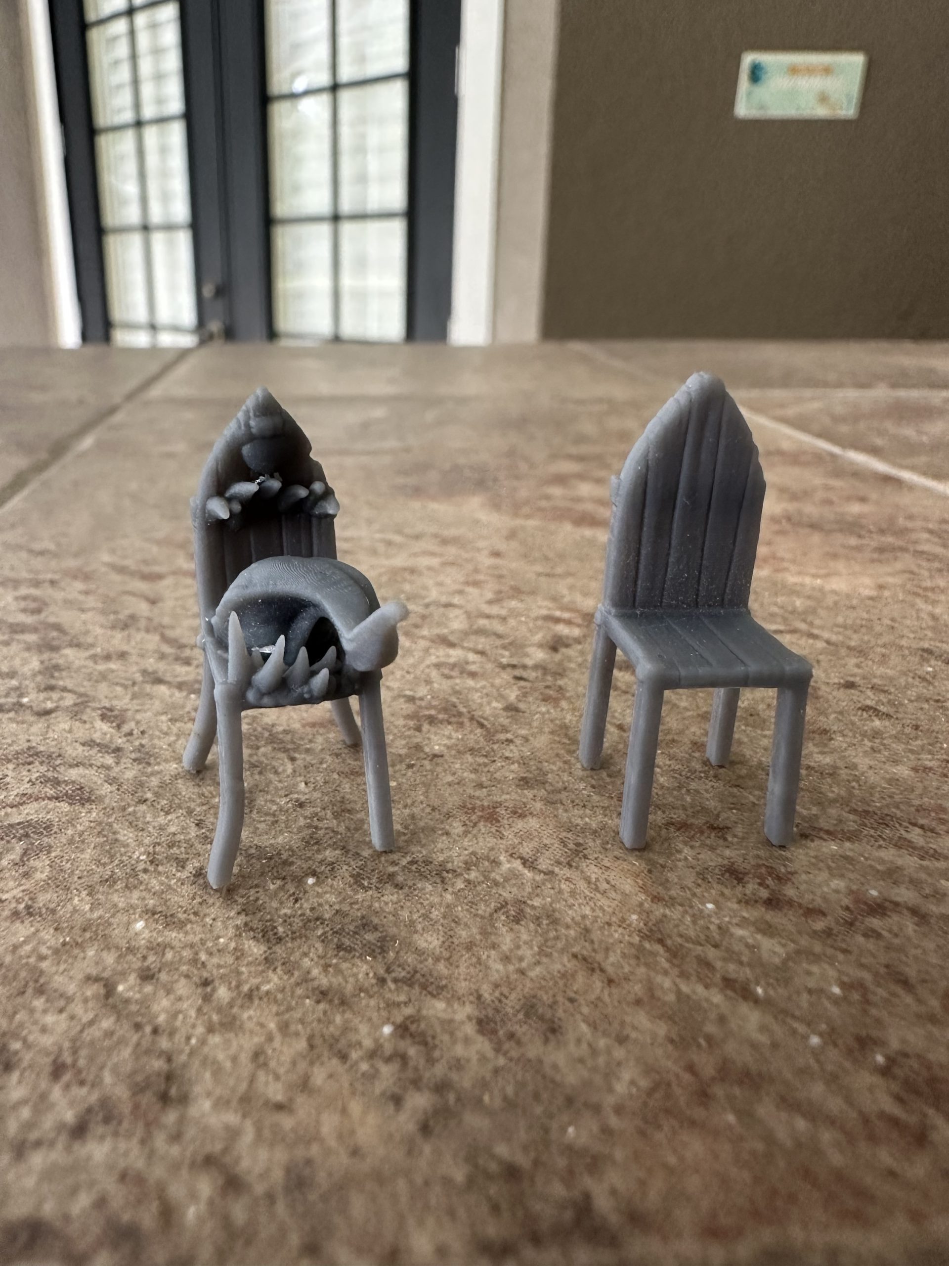 Chair mimic miniature set: a monster chair with a long tongue beside an innocent-looking chair