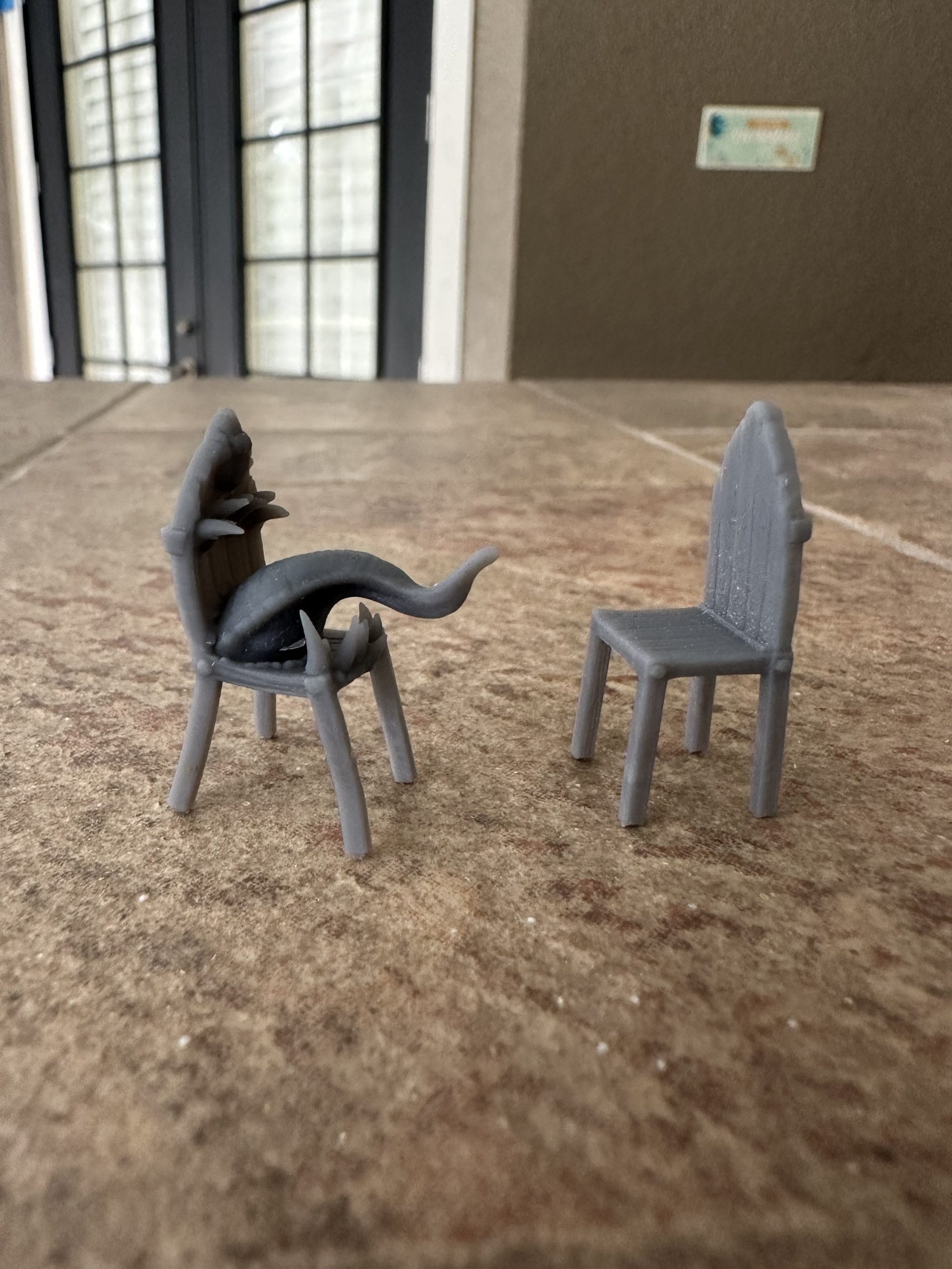 Chair mimic miniatures from the side, the mimic’s tongue reaching out