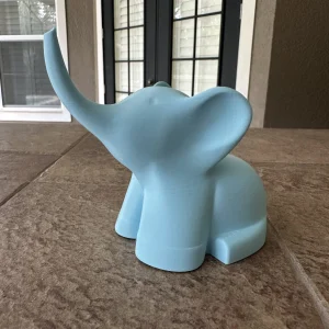 Light blue elephant ring holder with its trunk raised