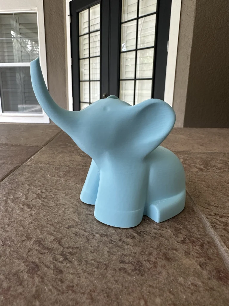 Light blue elephant ring holder with its trunk raised