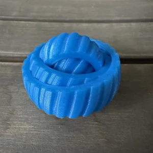 Blue interlocking fidget toy on a wooden table