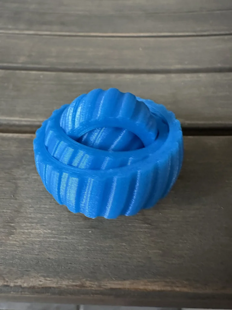 Blue interlocking fidget toy on a wooden table