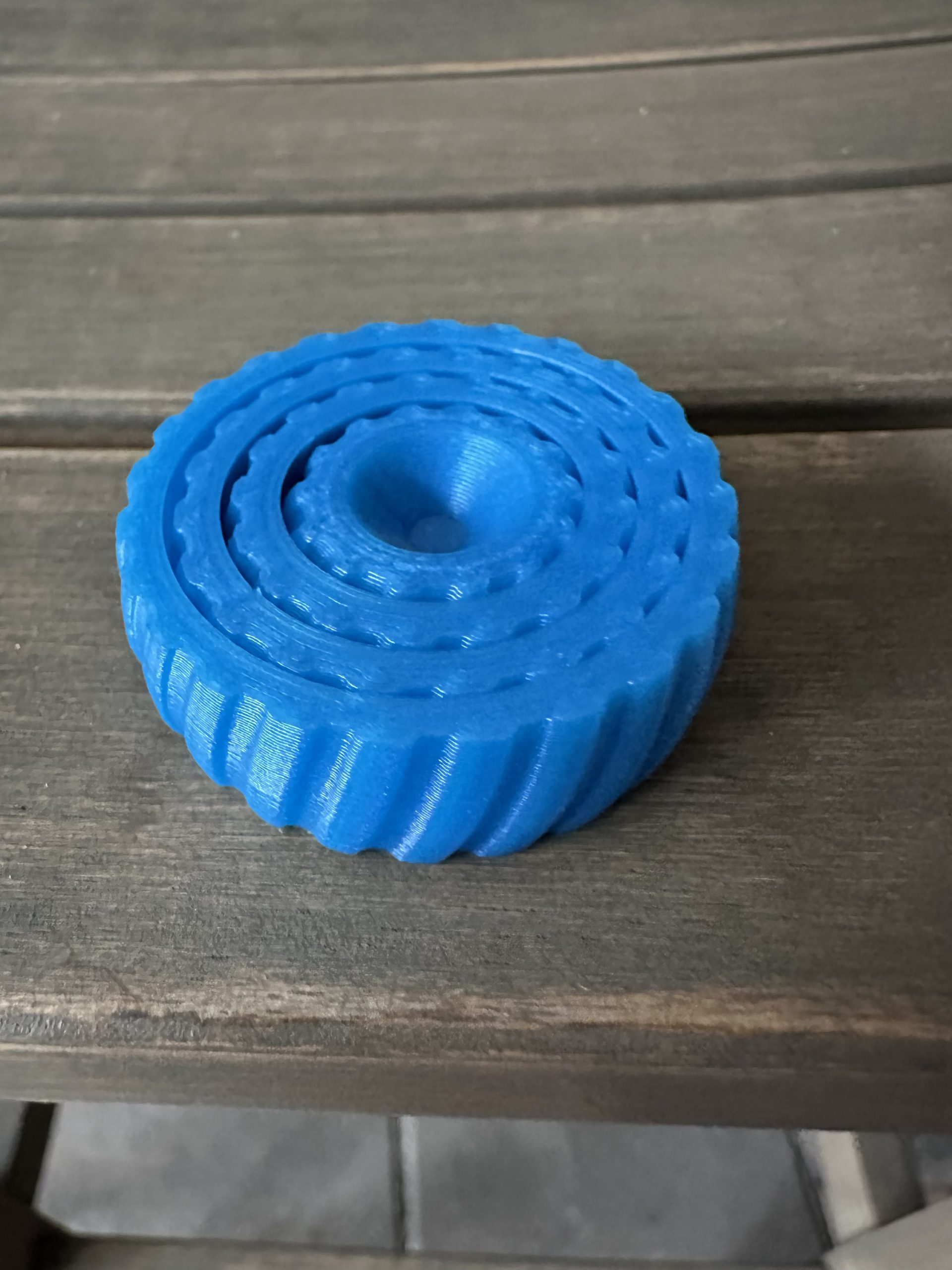 Blue interlocking fidget toy lying flat